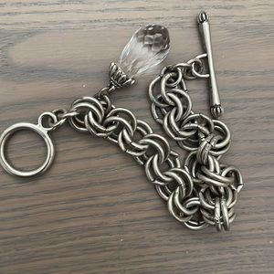 NEW silver toggle bracelet with charm.Approx. 8 inches in length.costume jewerly